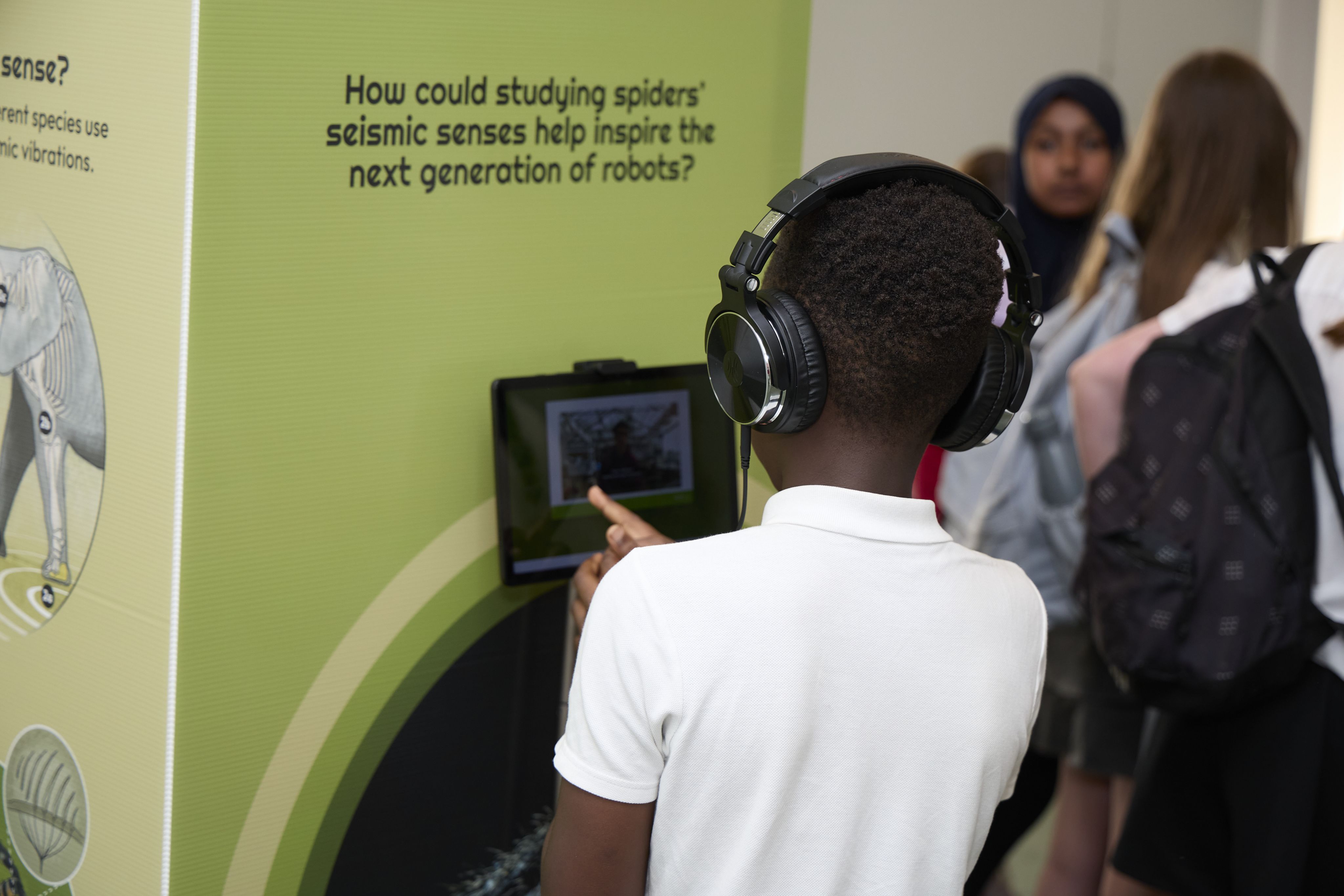 A young visitor watching a video at the exhibit 