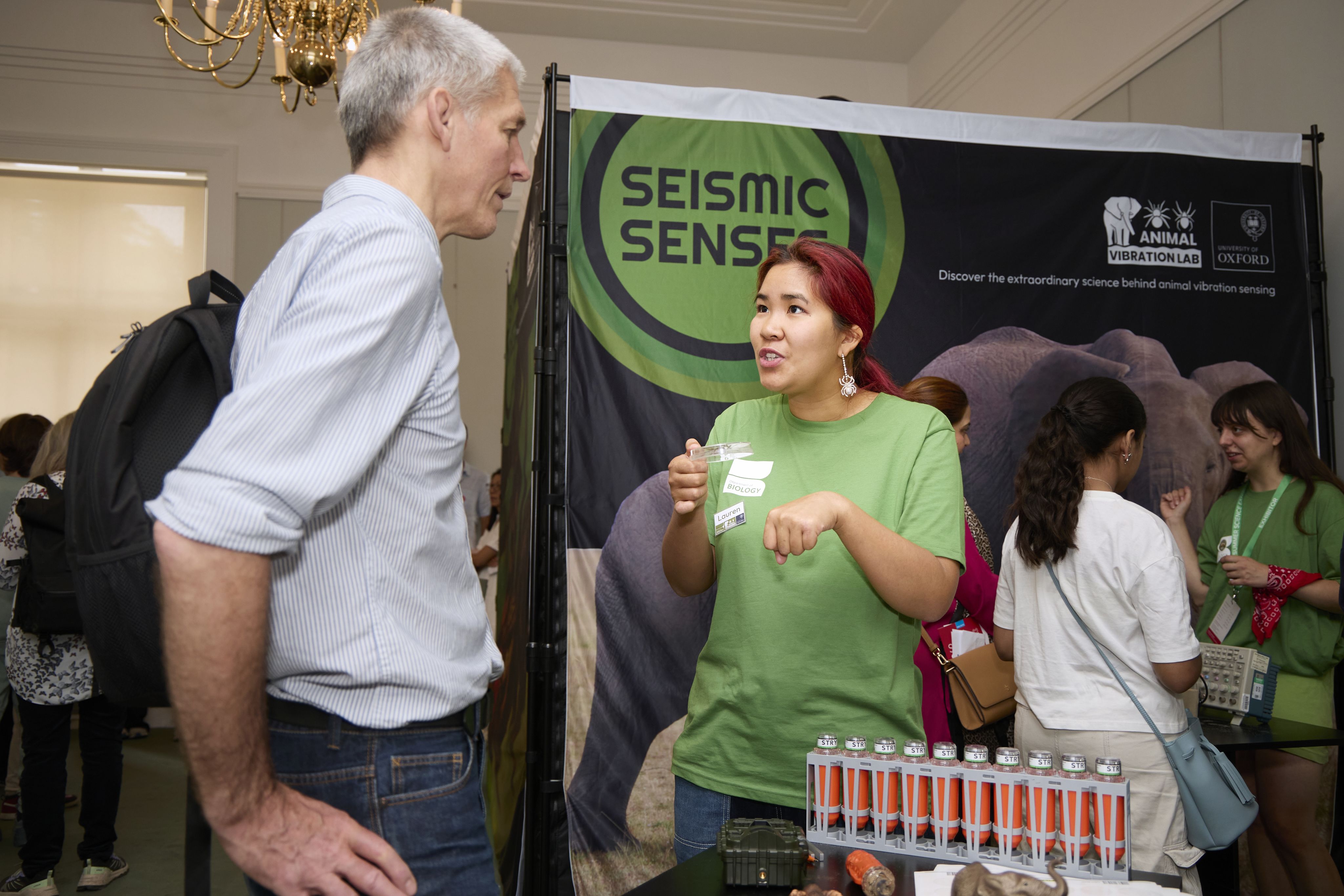 A researcher and exhibit visitor enganged in conversation 